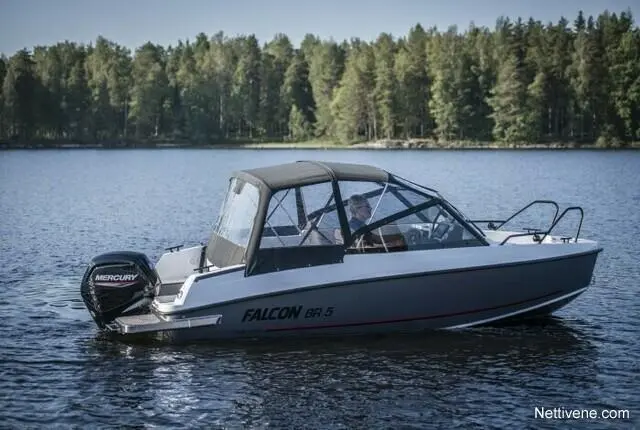 A Falcon BR 5 boat with a Mercury motor glides on calm water, surrounded by lush green trees.